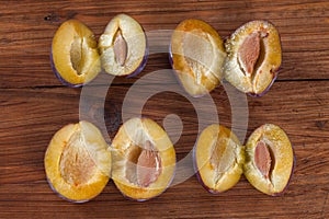 Plums on wood, halfed