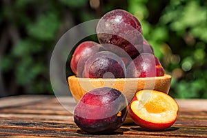 Pluot, mix of plum and apricot in wooden bowl