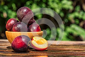 Pluot, mix of plum and apricot in wooden bowl