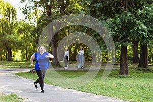 Plus size blonde girl jogging in the park. Concept on a healthy lifestyle and eliminating the effects of quarantine