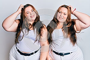 Plus size caucasian sisters woman wearing casual white clothes confuse and wonder about question