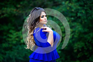 Plus size fashion model in blue dress outdoors, beauty woman with professional makeup and hairstyle