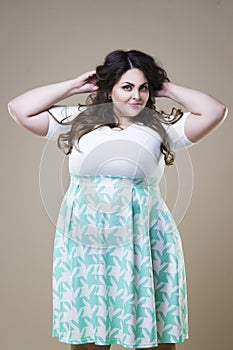 Plus size fashion model in casual clothes, fat woman on studio background, overweight female body