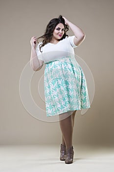 Plus size fashion model in casual clothes, fat woman on studio background, overweight female body