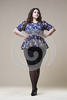 Plus size fashion model in casual clothes, fat woman on studio background, overweight female body