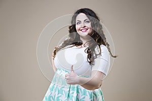 Plus size fashion model in casual clothes, fat woman on studio background, overweight female body