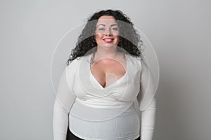 Plus size female model with happy toothy smile looking in camera