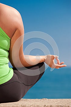 Plus size female practice yoga outdoor