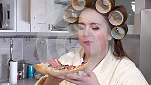 Plus size girl eats a slice of pizza