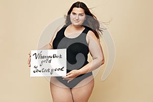 Plus Size Model. Full-figured Woman Portrait. Female Holding Motivational Poster With Inspiration Quote Written On Paper.