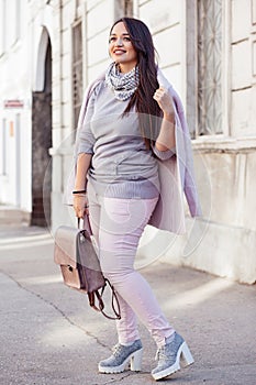 Plus size model in pink coat