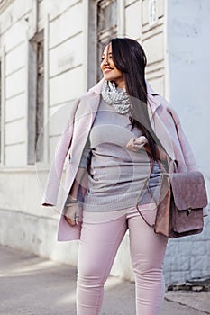 Plus size model in pink coat