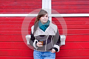 Plus size model in winter look with coffee