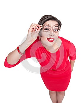 Plus size woman in glasses fixedly looking on you isolated. Top