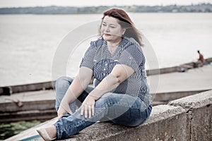 Plus size woman thinking about something, lifestyle