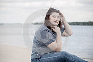 Plus size woman thinking about something, lifestyle