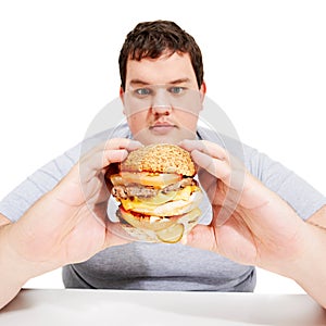Plus sized, eating and man holding burger, unhealthy diet and isolated hungry person and white background. Junk food