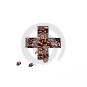 Plus summation sign or cross of coffee beans and cut paper isolated on white