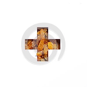 Plus summation sign or cross of raisins and cut paper isolated on white. Typeface made of dried grapes