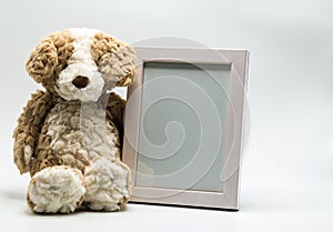 Plush teddy bear and empty picture frame