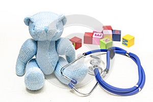 Plush teddy bears, stethoscopes and building blocks on the floor, symbolizing children`s health, medical and health care concept p