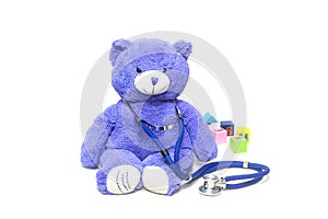 Plush teddy bears, stethoscopes and building blocks on the floor, symbolizing children`s health, medical and health care concept p