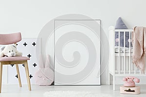 Plush toy on pink wooden chair next to empty poster with mockup