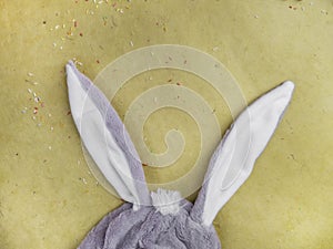 Plushy toy bunny rabbit ears. Happy easter concept. Yellow background. Easter minimal concept Picture with space for your text
