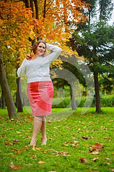 Plussize model in the autumn park