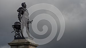 PLYMOUTH, DEVON, UK - March 06 2020: Sir Francis Drake statue overlooking The Hoe with storm clouds moving in photo