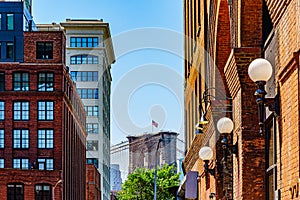 Plymouth St under Manhattan Bridge with view on element of Brooklyn Bridge with Amerian flag