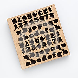 Plywood with laser-cut letters and numbers on it. on a white background