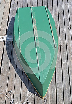 Plywood skiff on a wood deck photo
