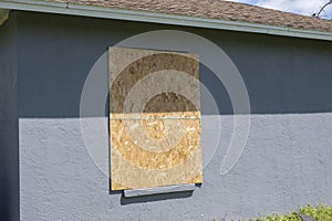 Plywood storm shutters for hurricane protection of house windows. Protective measures before natural disaster in Florida