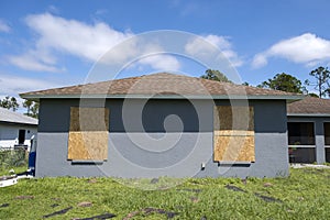 Plywood storm shutters for hurricane protection of house windows. Protective measures before natural disaster in Florida