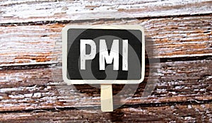 PMI - acronym from wooden blocks with letters, abbreviation PMI Private Mortgage Insurance, Purchasing Managers Index