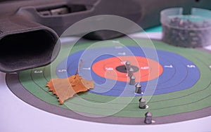 pneumatic shooting.air rifle and bullets on the background of a colored target.