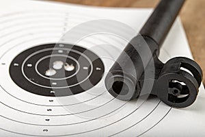 A pneumatic weapon on a wooden table on a shooting range. Shooting accessories needed for shooting sports