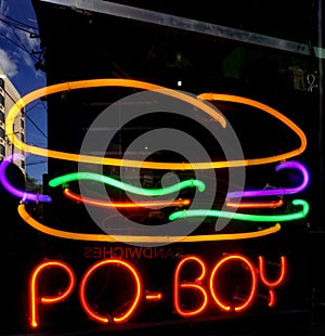 Po-Boy neon sign in a New Orleans French Quarter restaurant window photo