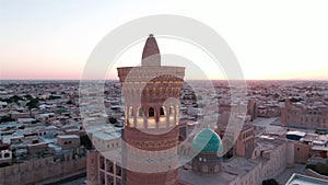 Po-i-Kalyan mosque complex in Bukhara and Kalyan Minaret at sunset, drone aerial