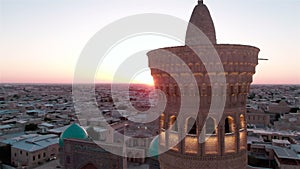 Po-i-Kalyan mosque complex in Bukhara and Kalyan Minaret at sunset, drone aerial