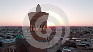 Po-i-Kalyan mosque complex in Bukhara and Kalyan Minaret at sunset, drone aerial