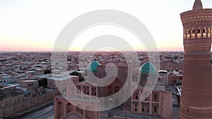 Po-i-Kalyan mosque complex in Bukhara and Kalyan Minaret at sunset, drone aerial