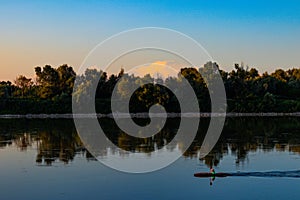 Po river kayaking at italian sunset summer