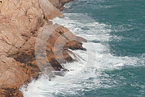 Po Toi Islands, big waves and dark rock in stormy sea Po Toi