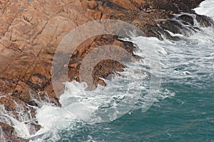 Po Toi Islands, big waves and dark rock in stormy sea Po Toi