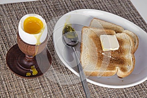 Poached egg in a wooden egg holder