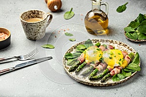 poached eggs benedict with green asparagus wrapped in grilled bacon, Ketogenic diet. Low carb high fat breakfast. Healthy food