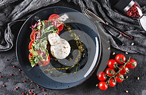 Poached eggs with fresh vegetable salad on grey plate background. Healthy vegetarian breakfast, clean eating, diet food, top view.