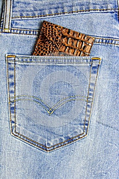 In the pocket of blue jeans inserted passport cover reptile leather